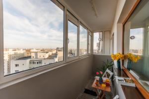 an apartment with windows and a view of the city at Apartament Sunset 12 in Bucharest