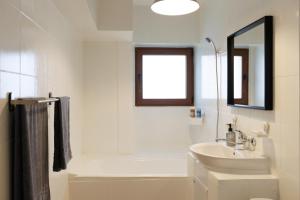 a white bathroom with a sink and a mirror at Apartament Sunset 12 in Bucharest +66 photos