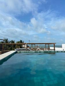a swimming pool with a view of the ocean at Home Beach at a Small Village in Cajueiro da Praia - Piauí - Brazil in Cajueiro
