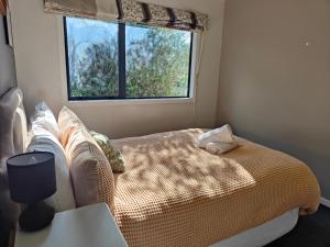 a bedroom with a bed and a window at Ohakune Peak Retreat Unit 1 in Ohakune