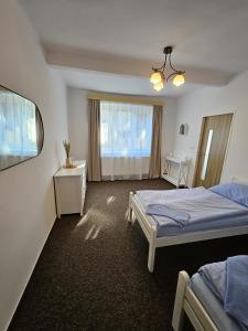 Postel nebo postele na pokoji v ubytování Rodinný apartmán U Kuby