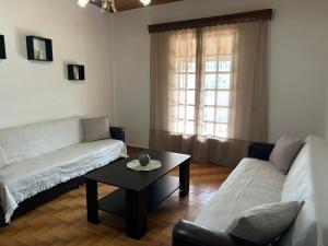 a living room with a couch and a coffee table at Christodoulos Villa in Agios Georgios