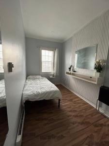 a small room with a bed and a window at Cosy Quinpool Rd - 2 Bedroom Apartment in Halifax