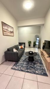 a living room with a couch and a table at Executive Apartment, Rosebank , Johannesburg in Johannesburg