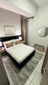 a bedroom with a large bed and a mirror at Executive Apartment, Rosebank , Johannesburg in Johannesburg