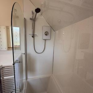 a bathroom with a shower and a bath tub at Mountain View House Kinlochleven in Kinlochleven