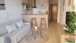 a living room with a couch and a table at Balcon al mar in Bellreguart