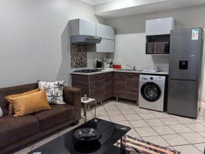 a living room with a couch and a kitchen at Your Perfect Escape with Breathtaking Lake Views in Pretoria
