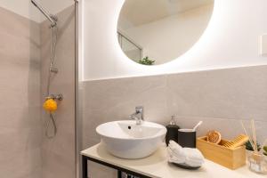 a bathroom with a sink and a mirror at Canvas Sevilla Lago in Seville +11 photos
