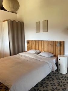 a bedroom with a large bed with a wooden headboard at San Bartolome Etxea 1 in Ea +18 photos