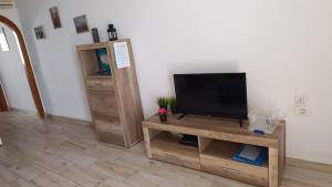 a living room with a television on a wooden table at Calle Hesperides in Costa Del Silencio