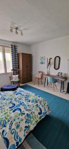 a bedroom with a bed with a blue and white blanket at Koppány Pines Rewild Escapes - Hungarian Village Vendeghaz in Koppányszántó +64 photos