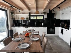 a kitchen with a wooden table with wine glasses on it at Villa Mimosa with private swimming pool in Ágios Márkos