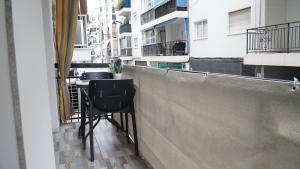 a balcony with a table and chairs on a building at Apartamento Altea Centro in Altea