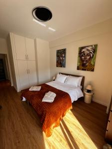 a bedroom with a bed with two towels on it at La Maison in Patra