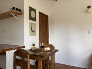 a room with a table with two glasses of wine at Jacaranda in Neptunia