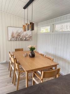a dining room with a wooden table and chairs at Vollsnes Feriehus in Hjelle +24 photos