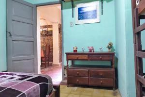 a bedroom with a dresser and a blue wall at La Franky en Termas de Río Hondo in Termas de Río Hondo +2 photos