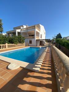a swimming pool in front of a house at Casa Ventura in Felanitx