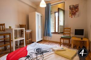 a small room with a bed and a tv at 4 Rooms in Plovdiv