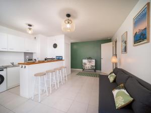 a living room and kitchen with a couch and a counter at Aqaba in La Ciotat