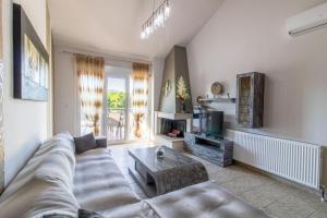 a living room with a couch and a coffee table at Dimitra Boutique Apartments 1 in Keramoti
