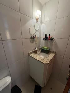 a bathroom with a sink and a toilet at Lindo apartamento com 2 suites in Rio de Janeiro