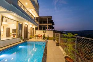 a house with a swimming pool on a balcony at Twilight Villa in Panchgani