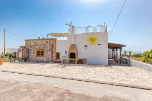 a large white house with a sun on the side at la casa del sole in Leuca