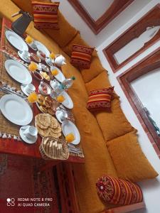 a table with plates of food on top of it at Dar Janarose in Essaouira