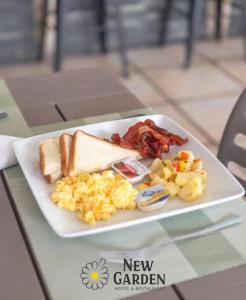 a plate of breakfast food on a table at New Garden Hotel in Sosúa
