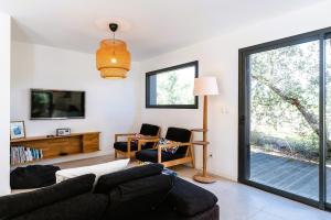 a living room with a couch and a tv at Villa cork contis 1 in Lit-et-Mixe