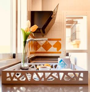 a kitchen with a sink with a vase and flowers at Hestía Vera Thalassa SPA Tu hogar lejos de casa in Vera