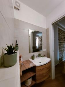 a bathroom with a sink and a mirror at La Stella del Viandante in Pietrapertosa