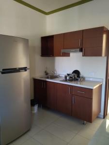 a kitchen with a sink and a refrigerator at Casa Quetzal in Peñita de Jaltemba