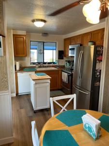 a kitchen with a stainless steel refrigerator and a table at The Lake House on Lake Rosalie in Lake Wales