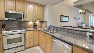 a kitchen with a sink and a microwave at 411 Mariners Club in Key Largo