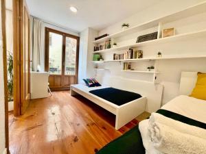 a bedroom with a large white bed and shelves at TOP APARTMENT frente a la Catedral in Pamplona