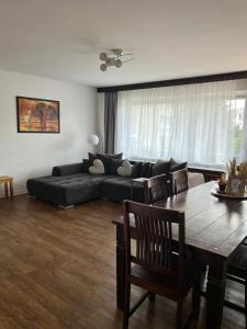 a living room with a couch and a table at Ferienhaus am Rhein Koblenz in Koblenz