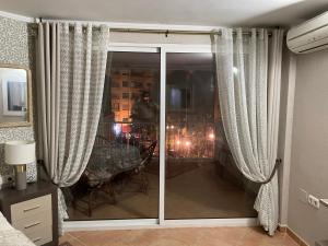 a sliding glass door in a room with a table at Marbella Apartment in Marbella +13 photos