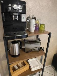 a shelf with a coffee maker and a microwave at Gästehaus Sylvie in Rust