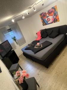a living room with a black couch in a room at Gästehaus Sylvie in Rust