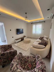 a living room with two couches and a tv at Villa PALA in Kemer +16 photos