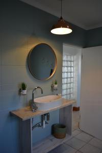 a bathroom with a sink and a mirror at Calypso beach holiday in Langebaan +38 photos