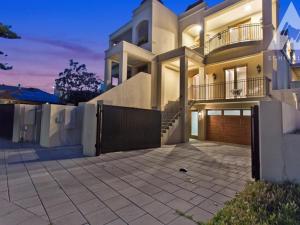 a large house with a fence and a driveway at Aria House - Henley Beach - Family Holiday Beachside BBQ in Henley Beach