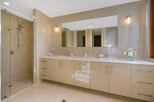 a bathroom with two sinks and a shower at Aria House - Henley Beach - Family Holiday Beachside BBQ in Henley Beach +21 photos