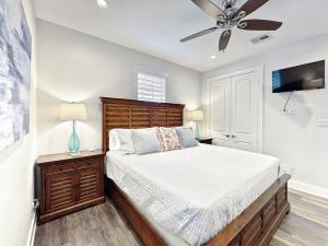Un dormitorio con una cama y un ventilador de techo. en Beachside Dream, Heated Poolhot Tub, 2 King Beds, en Galveston