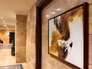 a large painting on a wall in a hallway at Quiet Rooms 12 Serviced Apartments in Riyadh