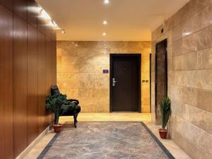 a hallway with a door and a chair in front of it at Quiet Rooms 12 in Riyadh