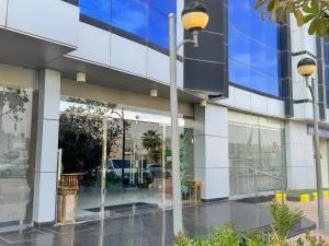 a building with a street light in front of it at Quiet Rooms 12 in Riyadh